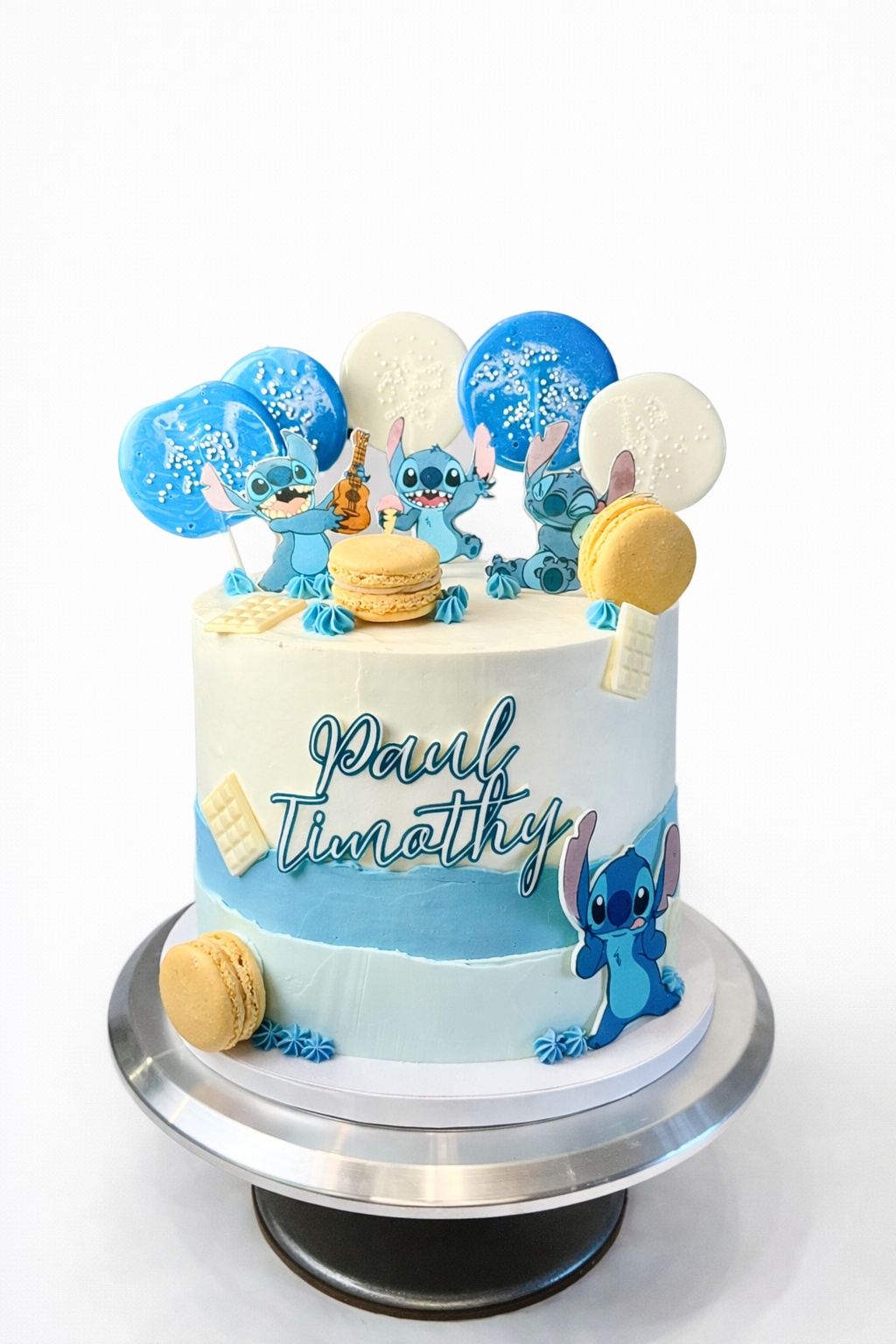 Stitch themed cake with lollipops and macarons