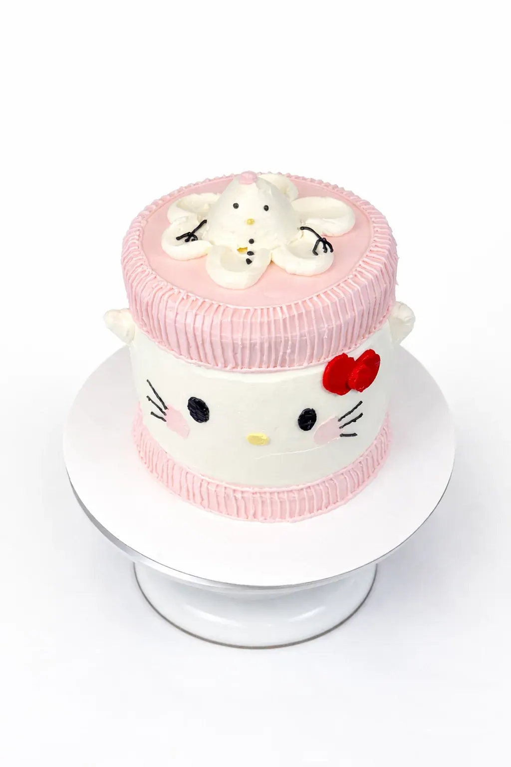 Hello Kitty cake in pink and white with a red bow
